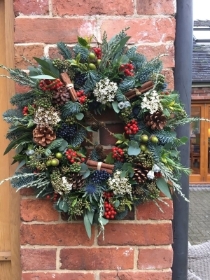 traditional wreath with berries and cinnamon