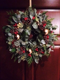 traditional wreath with berries and gold baubles